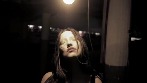 Female Zombie in a Trance Under a Light Bulb at 4K 120fps